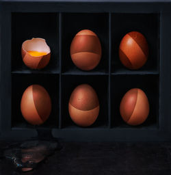 Close-up of orange eggs against black background