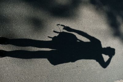 High angle view of silhouette person with shadow on street