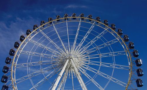 Low angle view of ferris wheel against sky