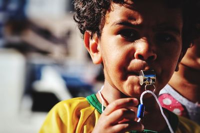 Close-up portrait of young man holding camera