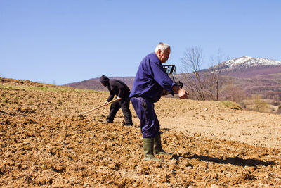 Full length of man on field against clear sky