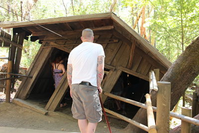 Rear view of man working on building