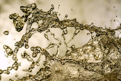 Close-up of water splashing on metal
