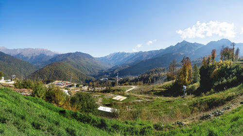 Scenic view of field and mountains against sky