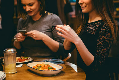 Young woman having food in restaurant