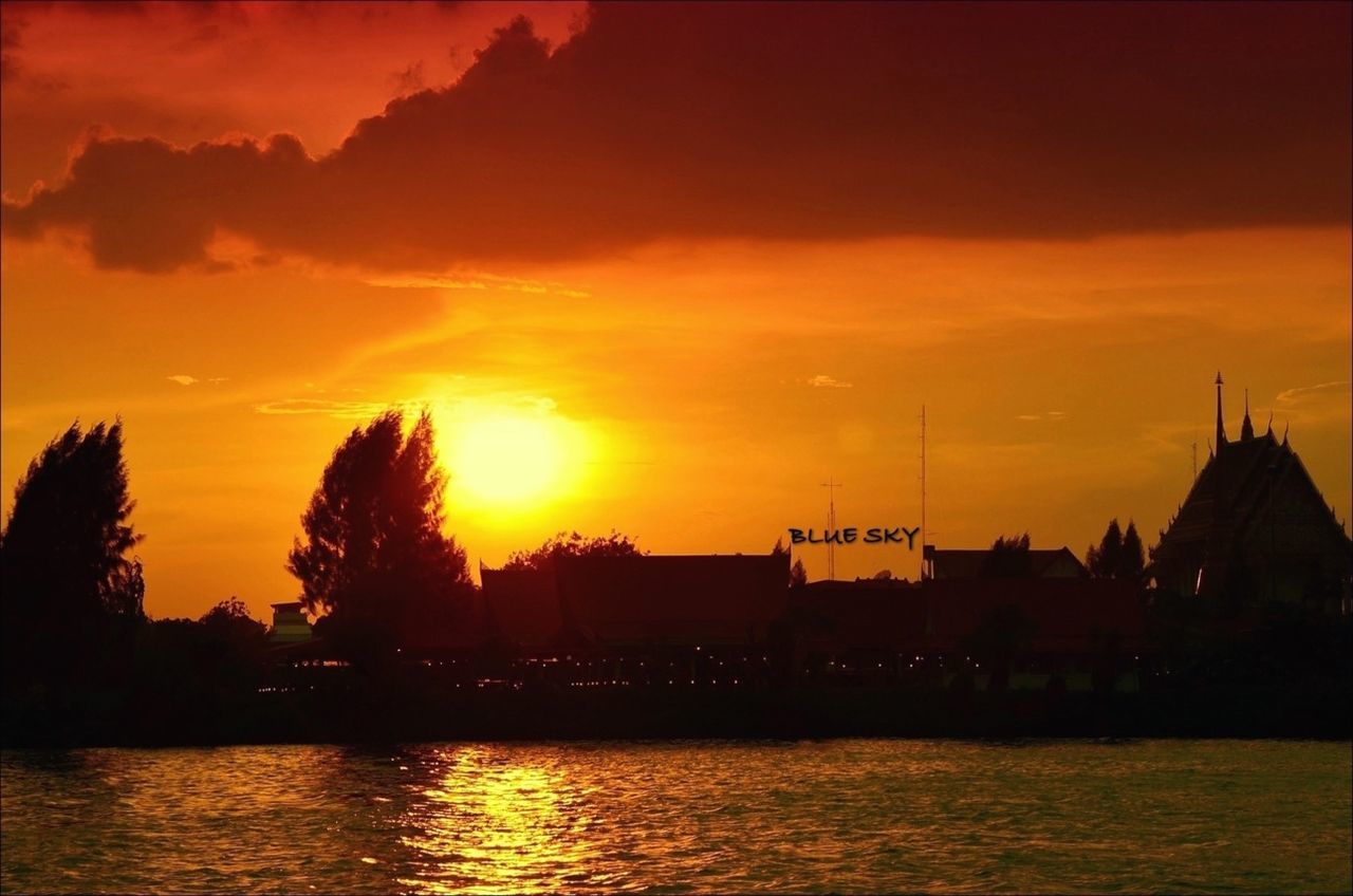 sunset, orange color, water, waterfront, silhouette, building exterior, architecture, sky, built structure, scenics, beauty in nature, river, sun, reflection, tranquil scene, tranquility, idyllic, nature, cloud - sky, rippled