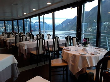 Empty chairs and tables in restaurant