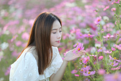 Beautiful woman with pink flower