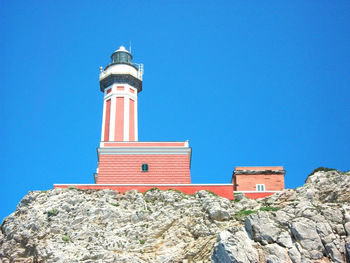 Low angle view of lighthouse against clear blue sky