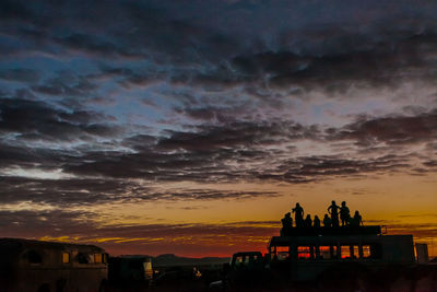 Silhouette of building against cloudy sky during sunset