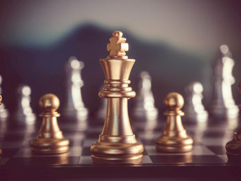 Close-up of chess pieces against gray background