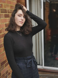 Portrait of a beautiful young woman standing outdoors