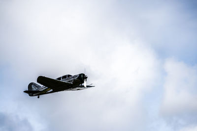 Low angle view of airplane flying in sky