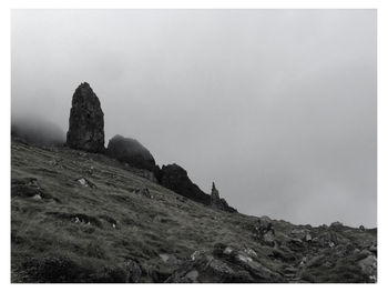 Low angle view of rocky mountain against sky