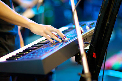 Midsection of woman playing piano