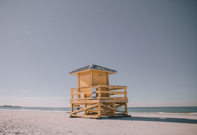 Lifeguard hut on beach against clear sky