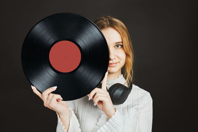 Woman with vinyl record. music passion. listening to music from analog record. retro music party