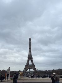 Silhouette of eiffel tower against cloudy sky