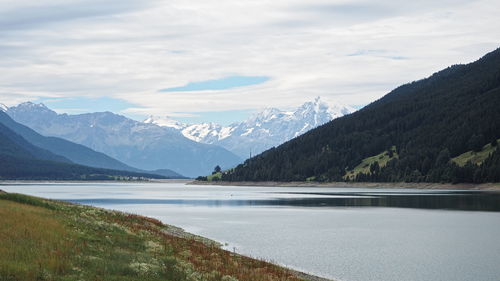 Scenic view of lake and mountains against sky