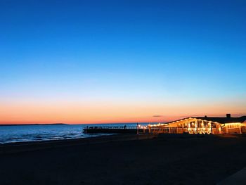 Scenic view of sea against clear sky at sunset