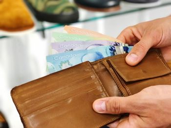 Close-up of hand removing money from wallet