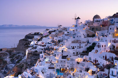 High angle view of townscape by sea against sky