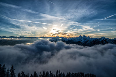 Scenic view of snowcapped mountains against sky at sunset