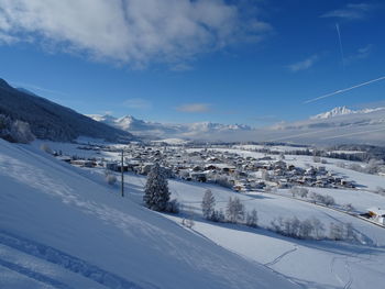 Snow covered landscape against sky