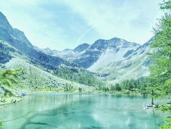 Scenic view of lake and mountains against sky