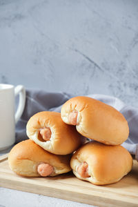 Sausage bun with a cup of coffee