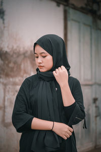 Portrait of young woman standing outdoors