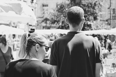 Rear view of people standing outdoors