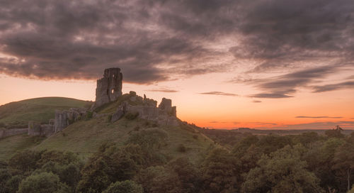 Scenic view of historic building against sky during sunset