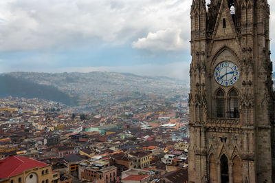 Clock tower with houses in background