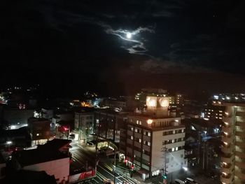 High angle view of illuminated buildings in city at night