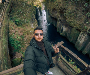 Portrait of smiling young man by river