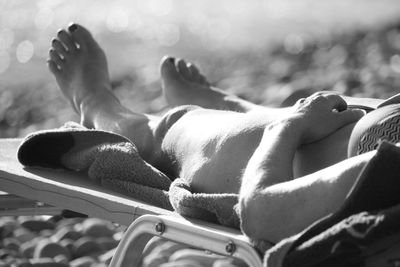 Low section of man sleeping on ground