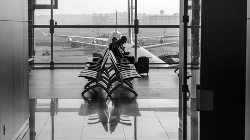 Rear view of people walking on tiled floor