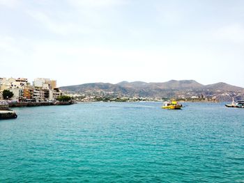 Scenic view of sea against sky in city