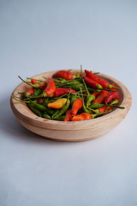 Close-up of salad on table against white background