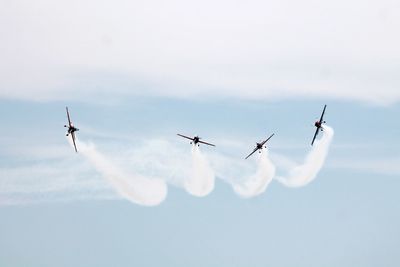 Low angle view of airshow in sky