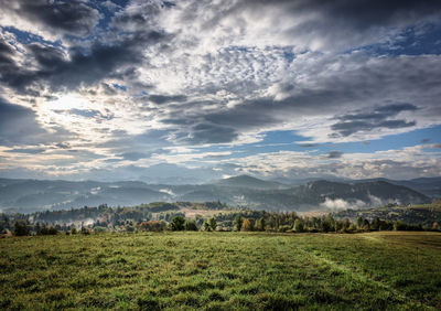Scenic view of landscape against cloudy sky