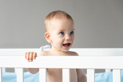 Portrait of cute baby boy sitting on table