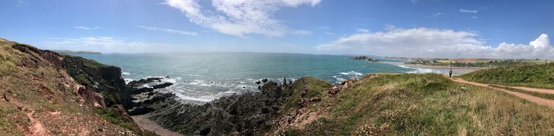 Panoramic view of sea against blue sky