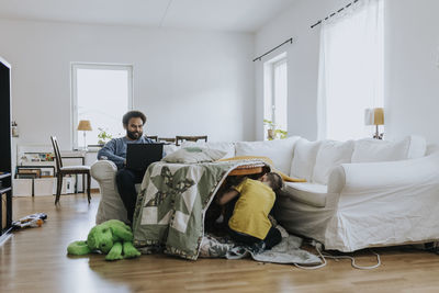 Man working from home and taking care of children