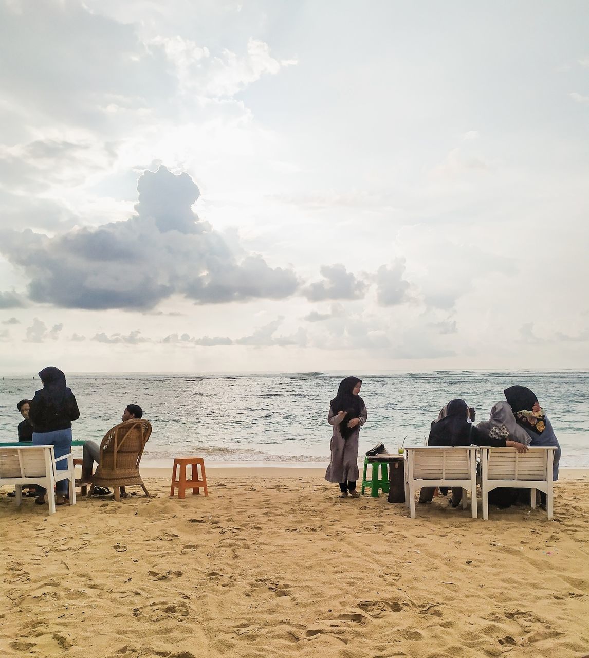 beach, land, sea, sky, sand, group of people, real people, sitting, water, cloud - sky, leisure activity, men, lifestyles, women, nature, beauty in nature, seat, scenics - nature, relaxation, outdoors, horizon over water