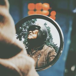 Close-up of woman standing against tree