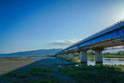 Bridge over river against clear sky