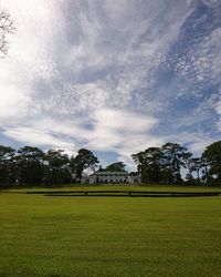 Scenic view of golf course against sky