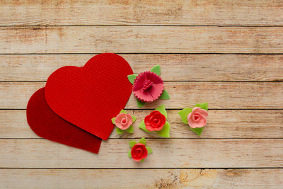 High angle view of heart shape on red table